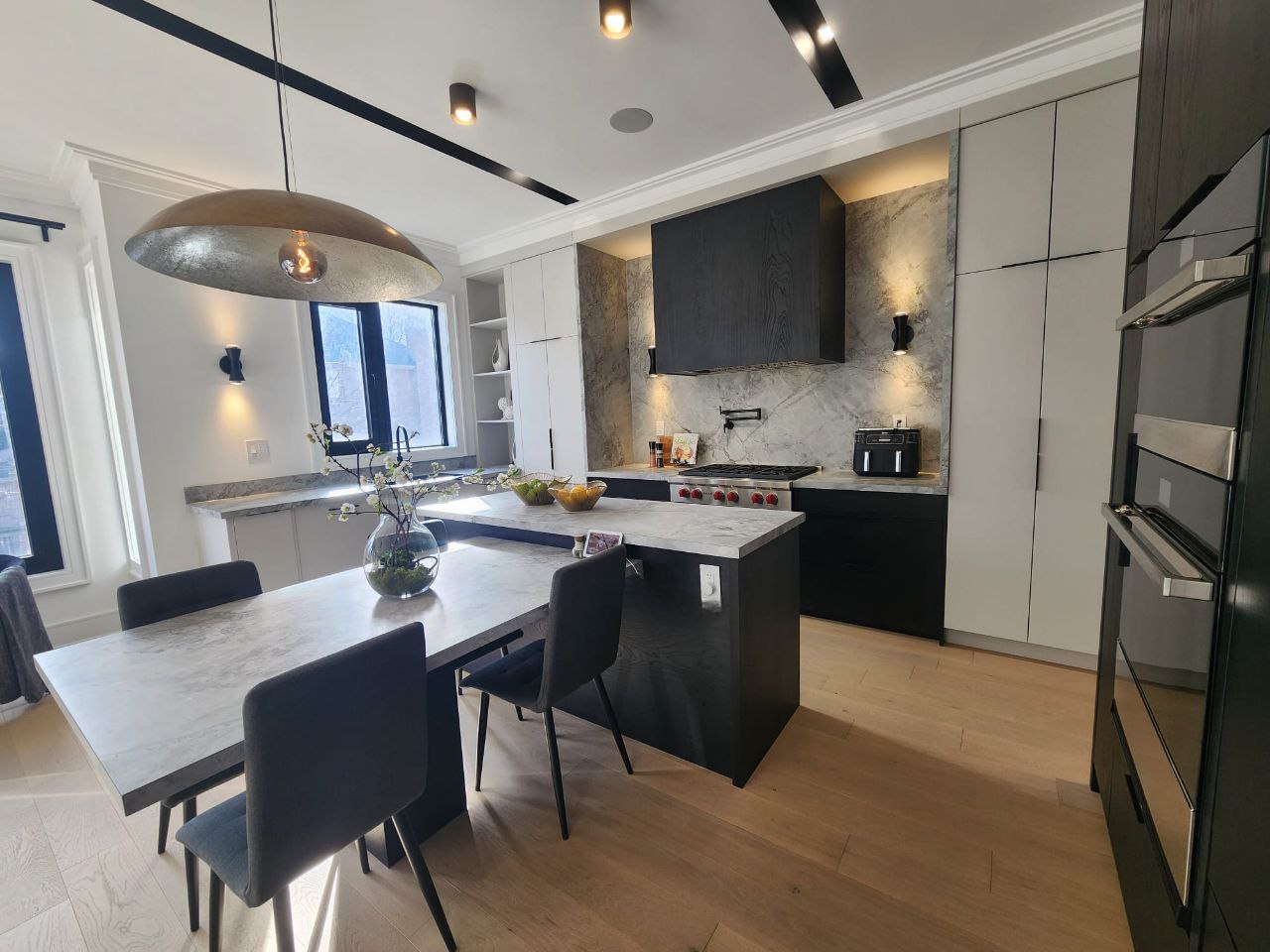 Gourmet kitchen with large center island and modern lighting