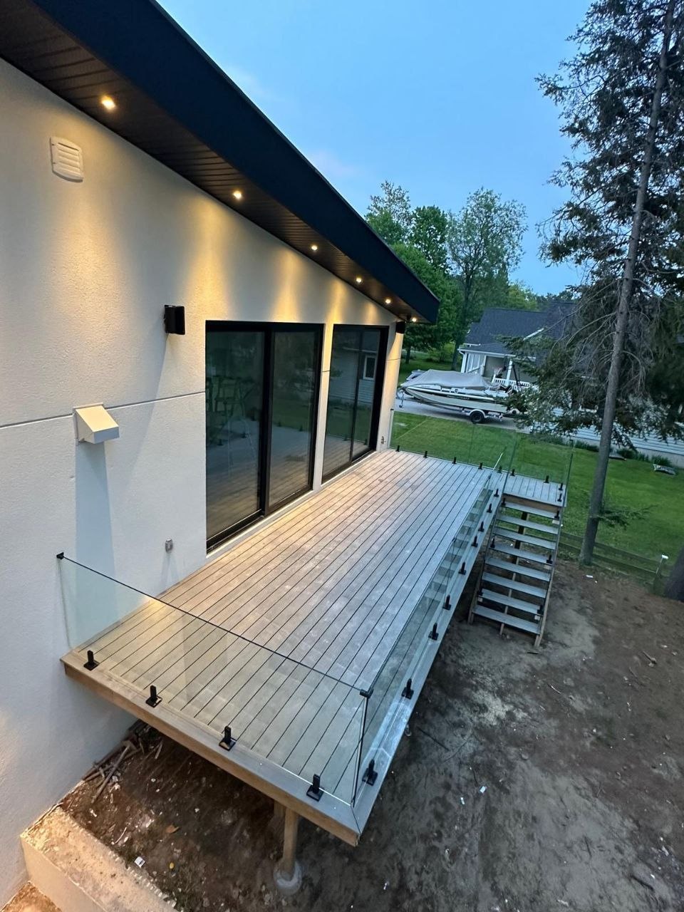 Exterior back view showing the stucco facade and composite deck